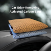 Two activated carbon car air purifying bags placed on car dashboard for odor and pollutant removal